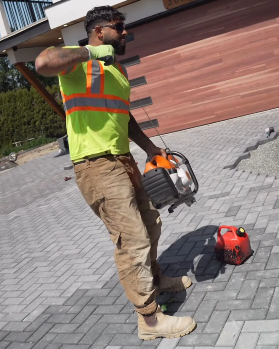 Jora Brar, founder of Trueform Hardscapes, on a completed paver driveway project in the Fraser Valley